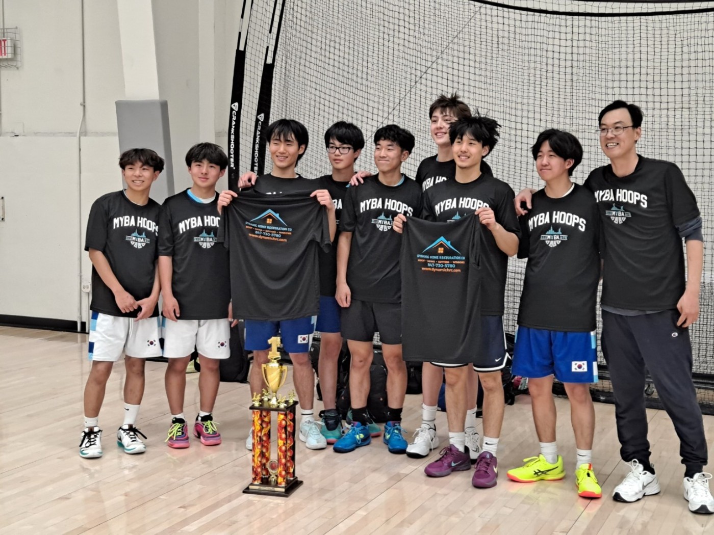 Older MYBA players and Coach Mark with their trophy